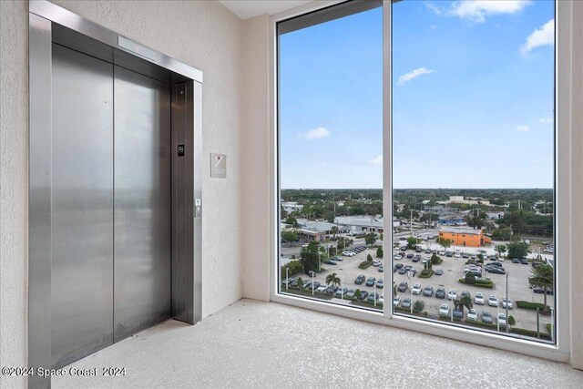 interior space featuring a closet, carpet flooring, and elevator