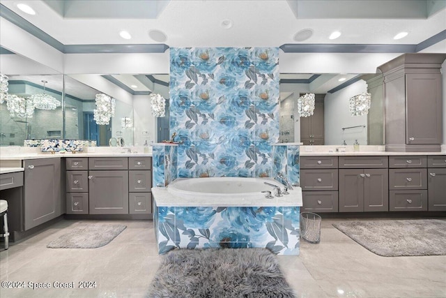 bathroom featuring tiled bath and vanity