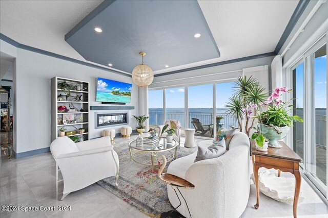 living room featuring built in shelves and a tray ceiling