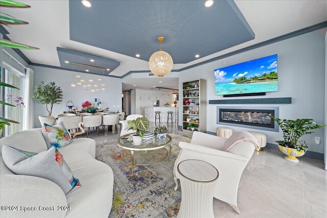 living room with a notable chandelier, light tile patterned floors, and ornamental molding