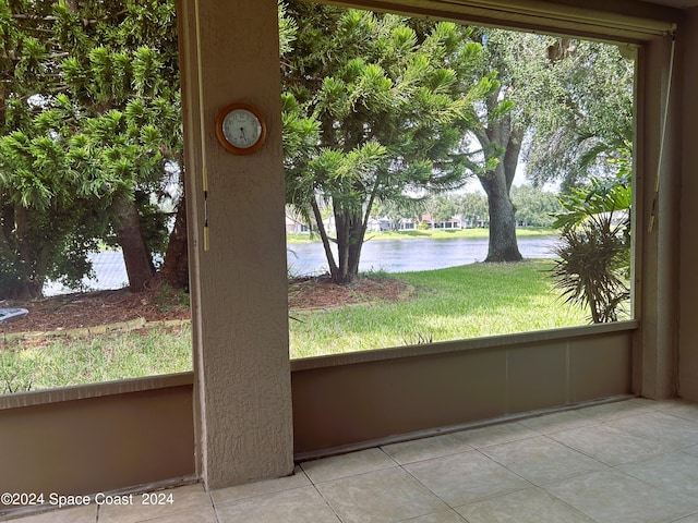 interior space with plenty of natural light and a water view