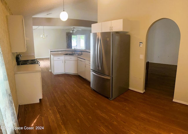 kitchen featuring dark hardwood / wood-style floors, sink, white cabinets, decorative light fixtures, and stainless steel fridge