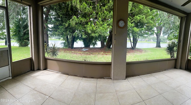 unfurnished sunroom featuring a water view and a healthy amount of sunlight