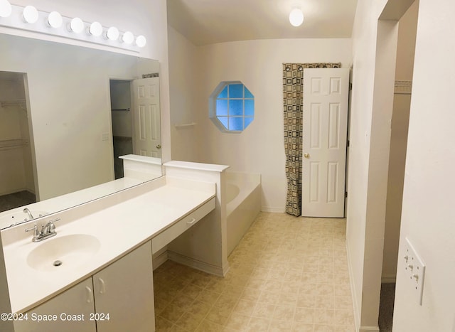 bathroom featuring vanity and a bath