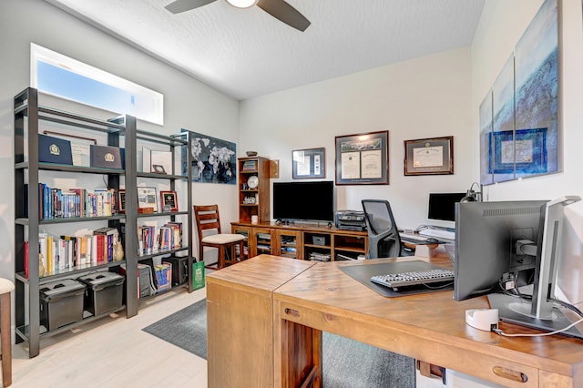 office featuring ceiling fan, a textured ceiling, and light hardwood / wood-style floors