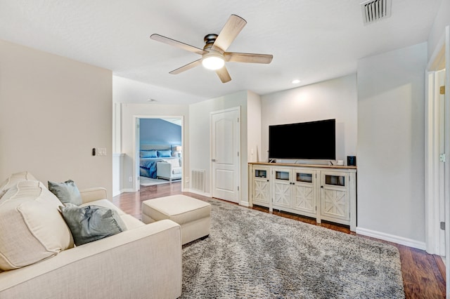 living room with hardwood / wood-style flooring and ceiling fan