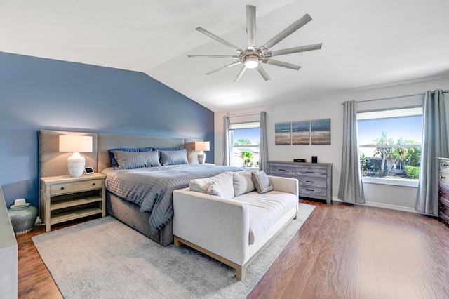 bedroom featuring ceiling fan, dark hardwood / wood-style floors, and vaulted ceiling