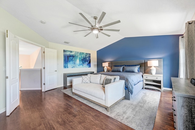 bedroom with ceiling fan, dark hardwood / wood-style floors, and lofted ceiling