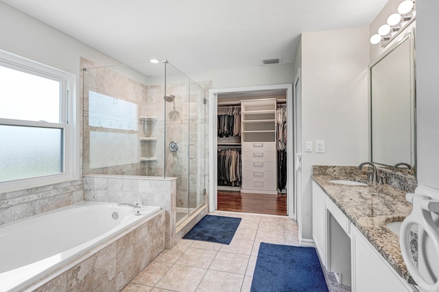 bathroom with vanity, independent shower and bath, and tile patterned floors