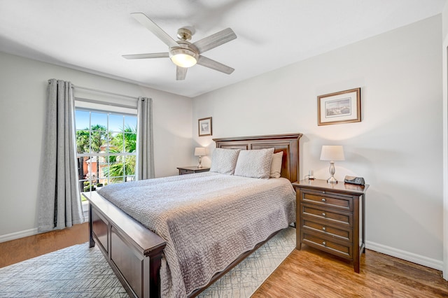 bedroom with light hardwood / wood-style floors and ceiling fan