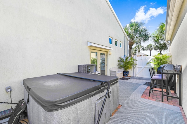 view of patio with a hot tub and central AC