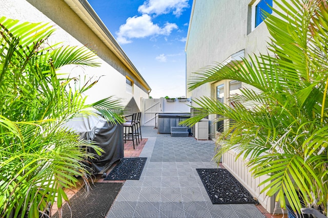 view of patio / terrace with a hot tub