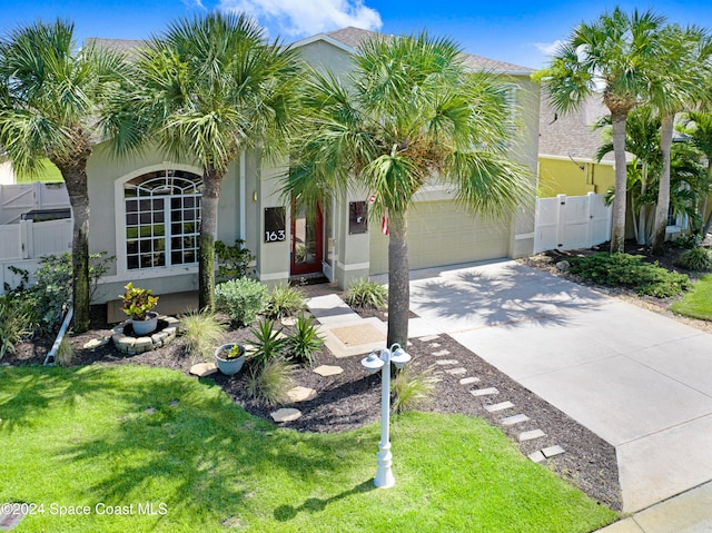 view of front facade with a garage and a front lawn