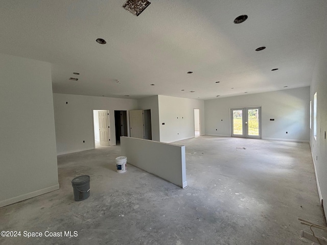 spare room with french doors and a textured ceiling