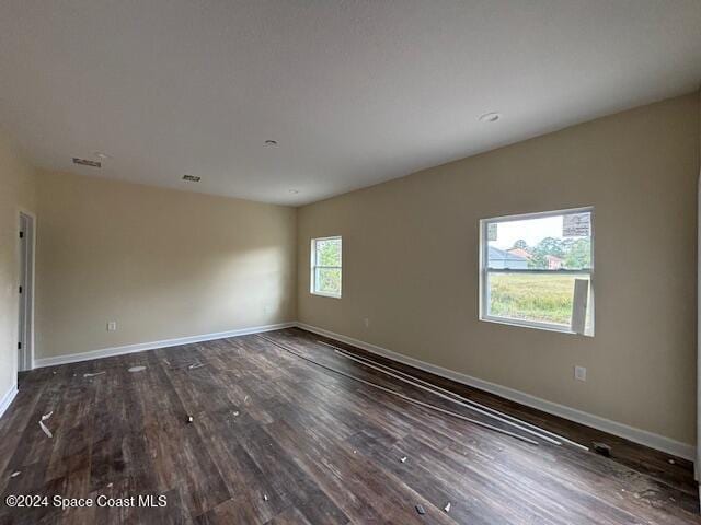 spare room featuring dark hardwood / wood-style floors