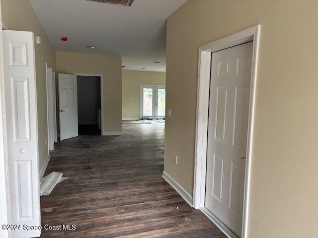 hall featuring french doors and dark hardwood / wood-style flooring