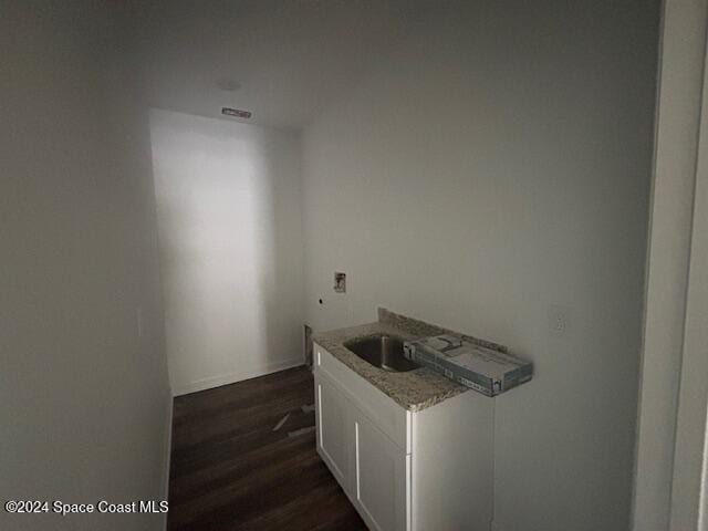 interior space with sink and dark wood-type flooring