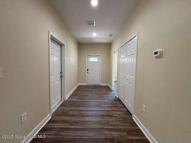 3250 San Jose Ave SE, Palm Bay, FL 32909 - doorway featuring dark wood finished floors, baseboards, and recessed lighting