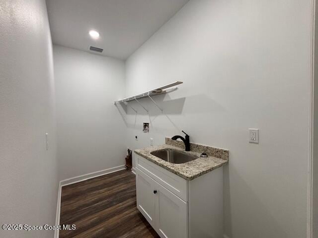 3250 San Jose Ave SE, Palm Bay, FL 32909 - laundry room featuring washer hookup, dark wood-type flooring, baseboards, recessed lighting, and cabinet space