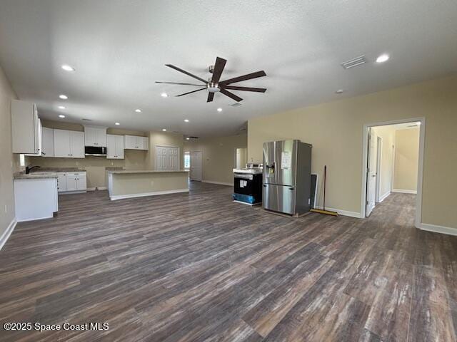 3250 San Jose Ave SE, Palm Bay, FL 32909 - kitchen featuring appliances with stainless steel finishes, open floor plan, dark wood-style flooring, a ceiling fan, and baseboards