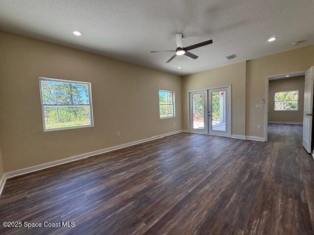 3250 San Jose Ave SE, Palm Bay, FL 32909 - spare room featuring a ceiling fan, dark wood-style floors, french doors, plenty of natural light, and a textured ceiling
