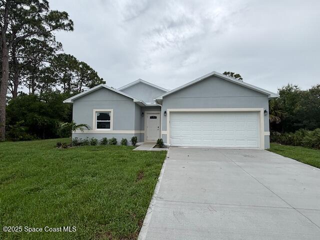 3250 San Jose Ave SE, Palm Bay, FL 32909 - ranch-style home featuring an attached garage, concrete driveway, a front yard, and stucco siding