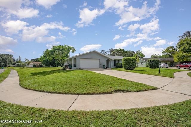 ranch-style house featuring a garage and a front lawn