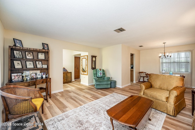 living room featuring light hardwood / wood-style flooring and a chandelier