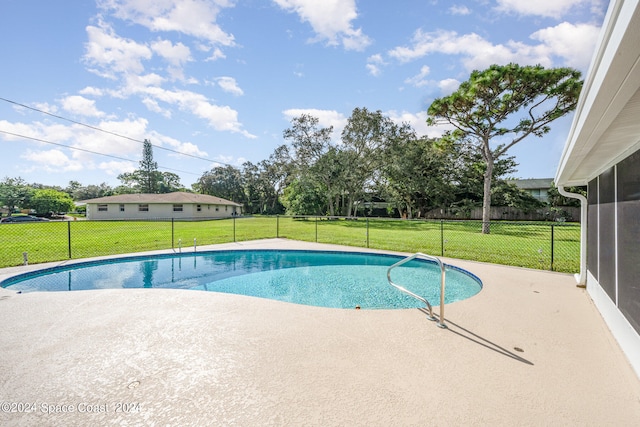 view of swimming pool featuring a yard and a patio