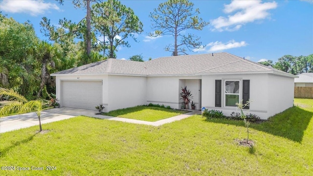 ranch-style house featuring a garage and a front yard