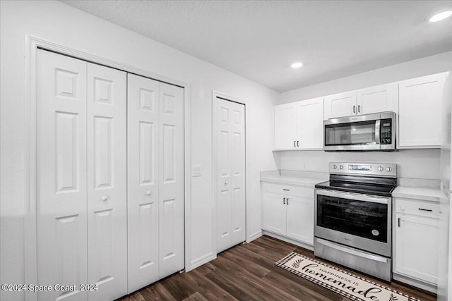 kitchen featuring white cabinets, stainless steel appliances, and dark wood-type flooring