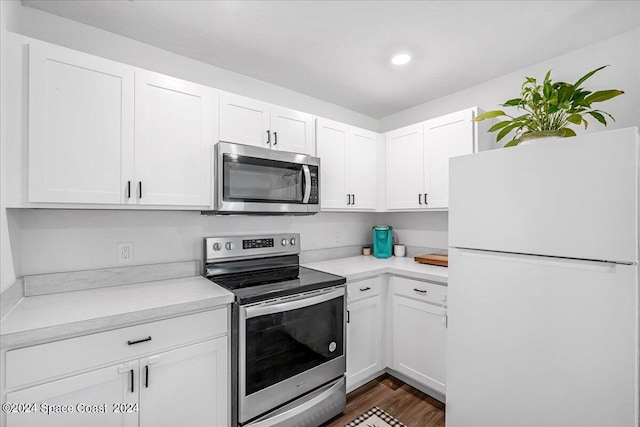 kitchen featuring white cabinets, stainless steel appliances, and dark hardwood / wood-style floors