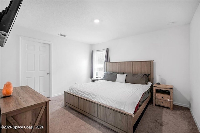 bedroom featuring light colored carpet