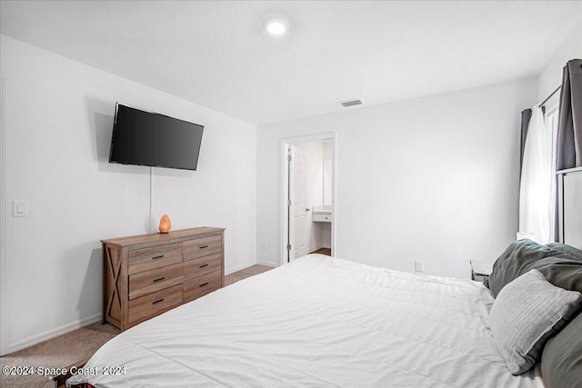 carpeted bedroom with ensuite bath