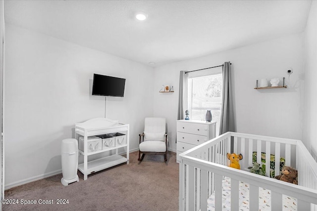 carpeted bedroom with a crib