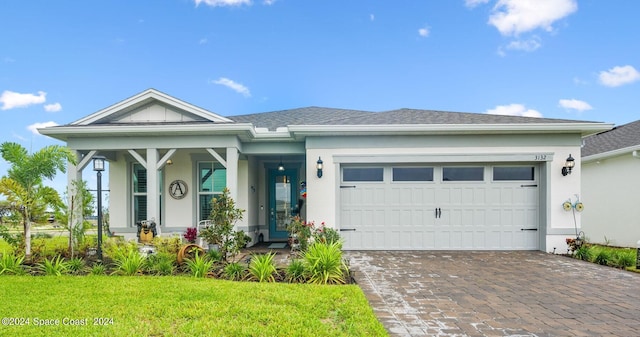 view of front of property with a front lawn, a porch, and a garage