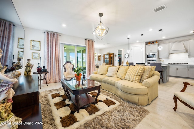 living room featuring recessed lighting, visible vents, and light wood finished floors