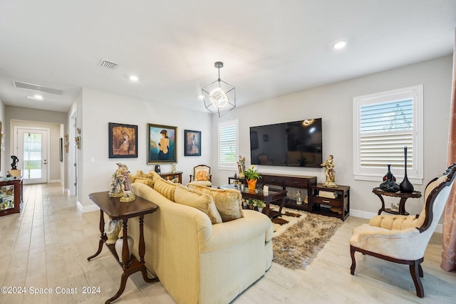 living room with baseboards, recessed lighting, and a healthy amount of sunlight