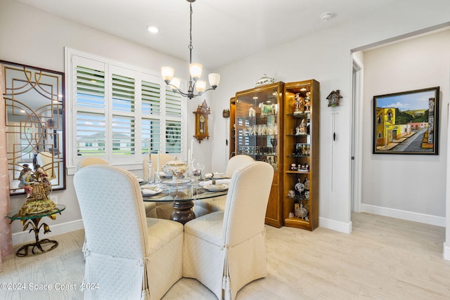 dining space with baseboards, recessed lighting, light wood-style flooring, and a notable chandelier