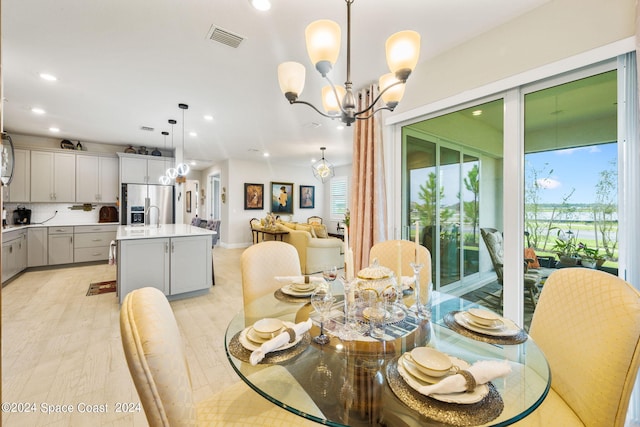 dining area with visible vents, recessed lighting, a healthy amount of sunlight, and an inviting chandelier