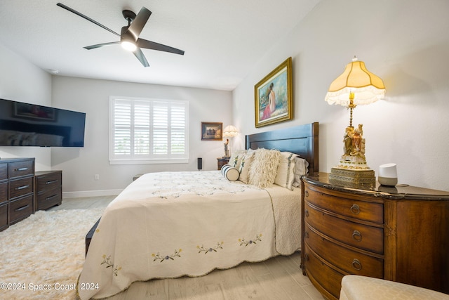 bedroom with light hardwood / wood-style floors and ceiling fan