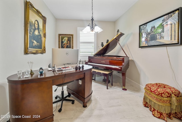 home office featuring light hardwood / wood-style floors and an inviting chandelier