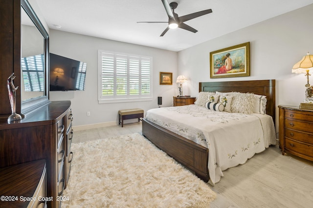 bedroom with baseboards, ceiling fan, and light wood finished floors