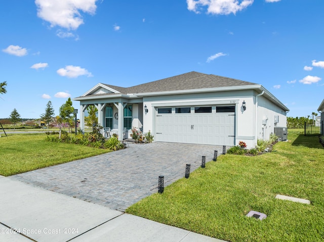 ranch-style home with a porch, decorative driveway, an attached garage, and a front yard