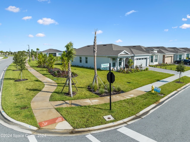 ranch-style home with a garage and a front lawn