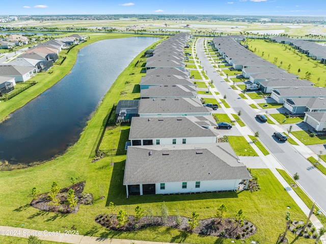 birds eye view of property featuring a water view and a residential view