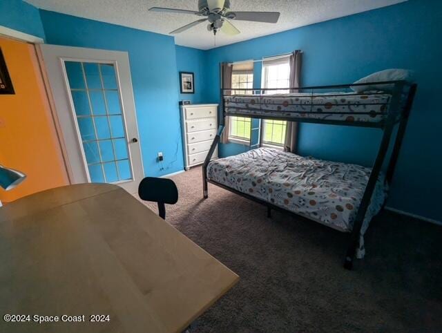 carpeted bedroom with a textured ceiling and ceiling fan