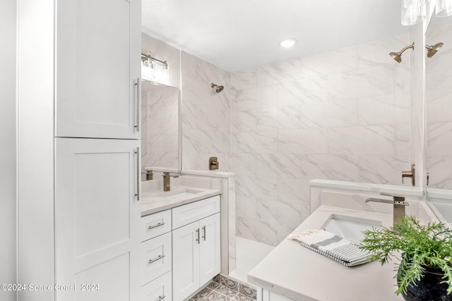 bathroom with tile walls, vanity, and a tile shower