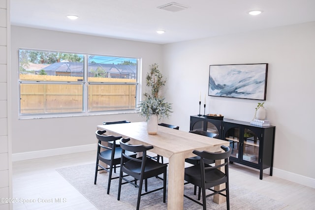 dining area with light hardwood / wood-style floors