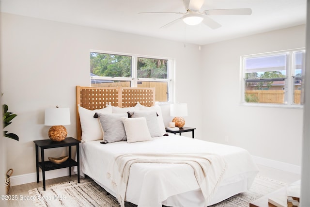 bedroom with ceiling fan and hardwood / wood-style flooring